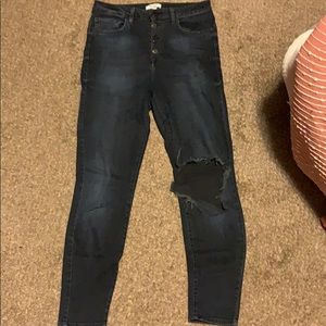 High waisted dark denim jeans with large rip